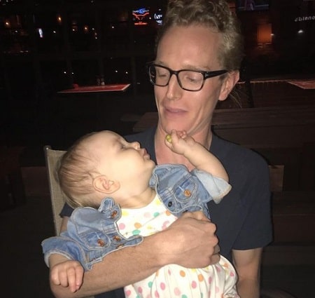 Leslie's husband Evan holding their beautiful daughter